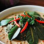**Comorian Mataba:** A close-up photo of Mataba, featuring taro leaves simmered in coconut milk with spices. Emphasize the texture and rich color of the dish, highlighting the blend of ingredients.